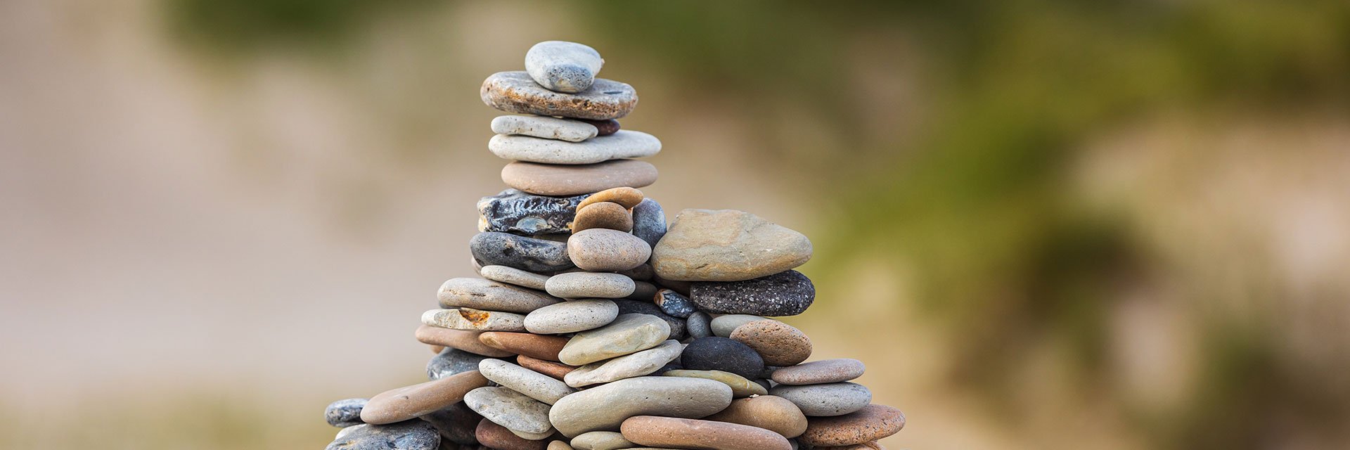 A pile of flat stones on the beach.